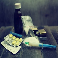 Drugs, needles and paraphernalia on a table