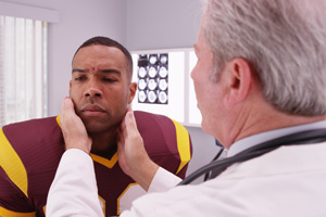 football player examined for concussion